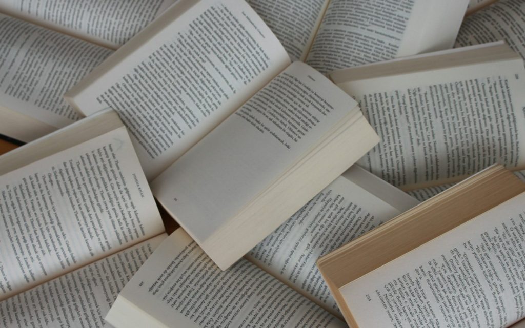 pile of open paperback books